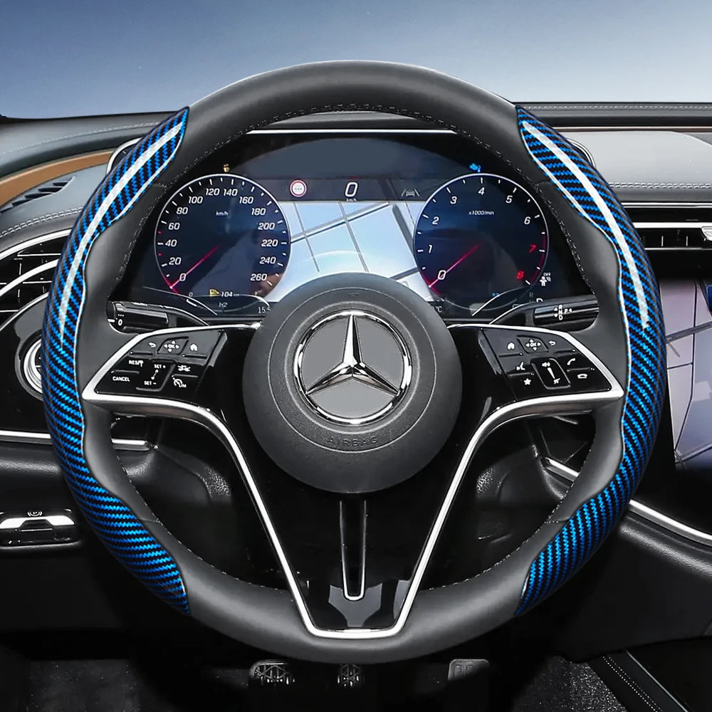Close-up view of a black steering wheel with blue carbon fiber texture accents and a Mercedes-Benz logo.