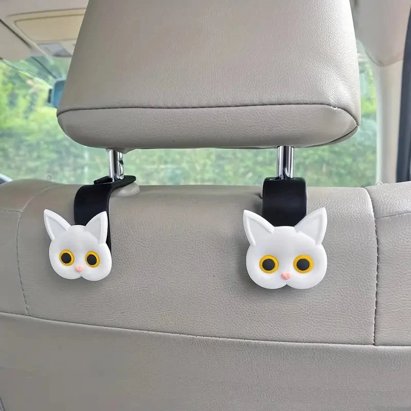 Gray car headrest hooks featuring white 3D cartoon cat heads for universal storage
