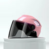 A pink lightweight rainproof half helmet is displayed on a white circular stand.