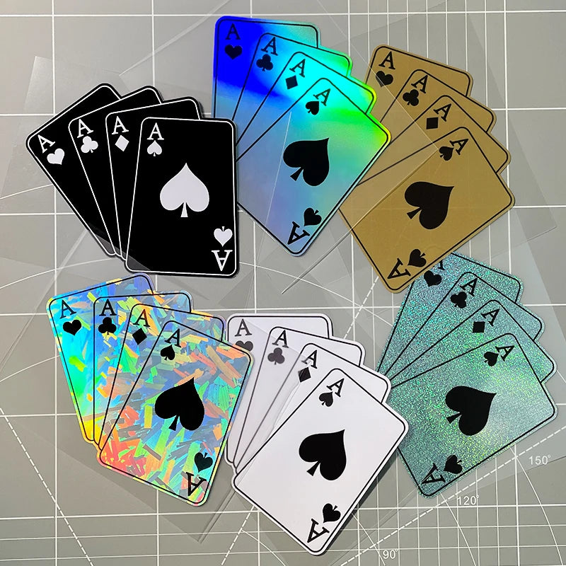 A collection of various colored playing cards scattered on a gray surface.