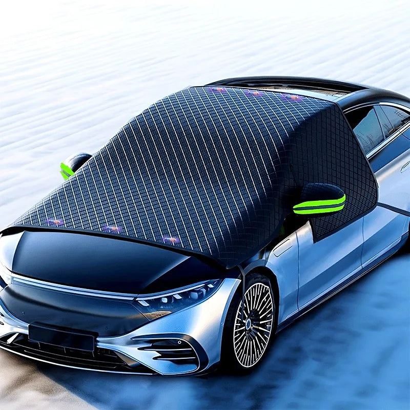 A silver car with a black magnetic anti-frost windshield sunshade covering the front windshield.