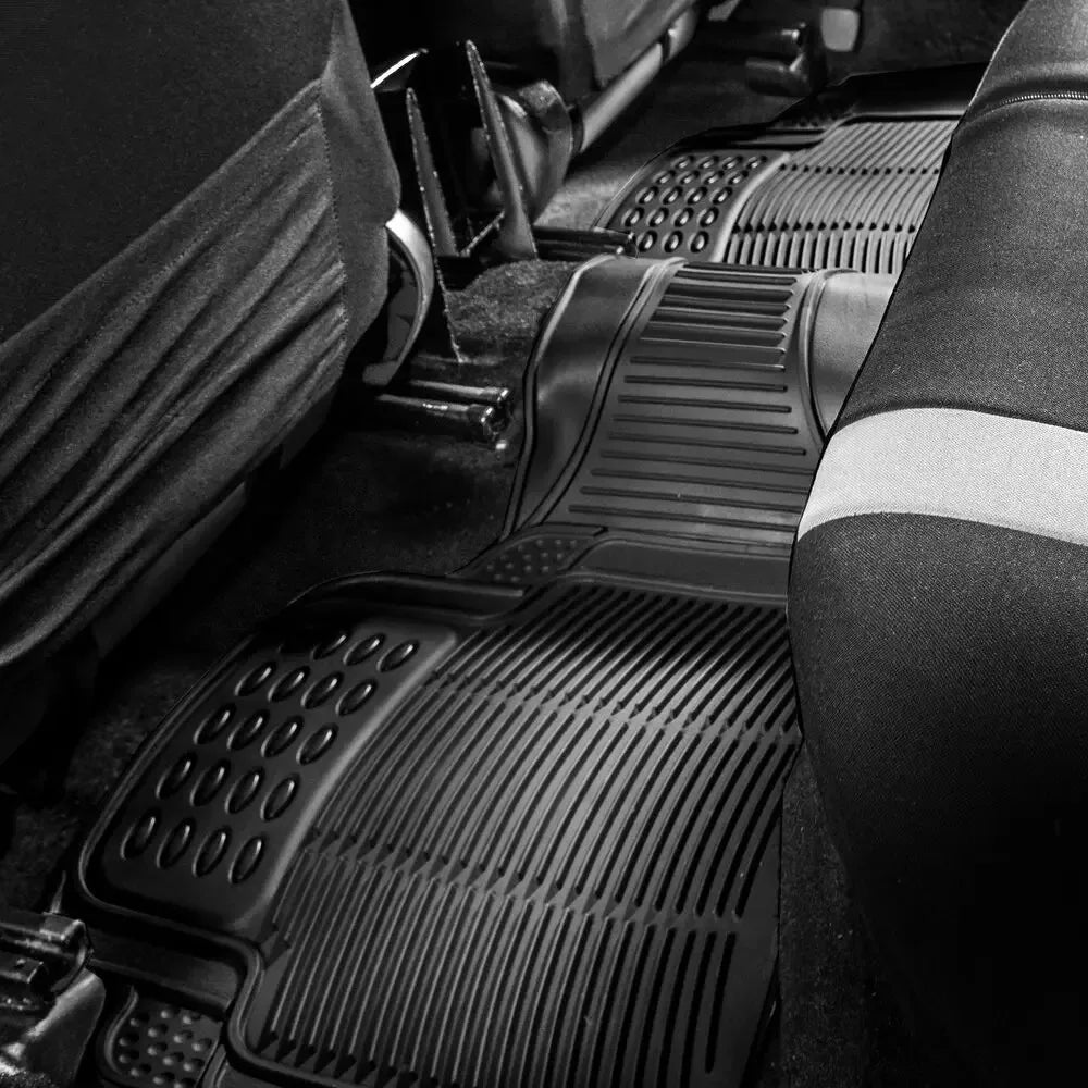 Close-up view of a black heavy-duty rubber floor mat set installed in a vehicle