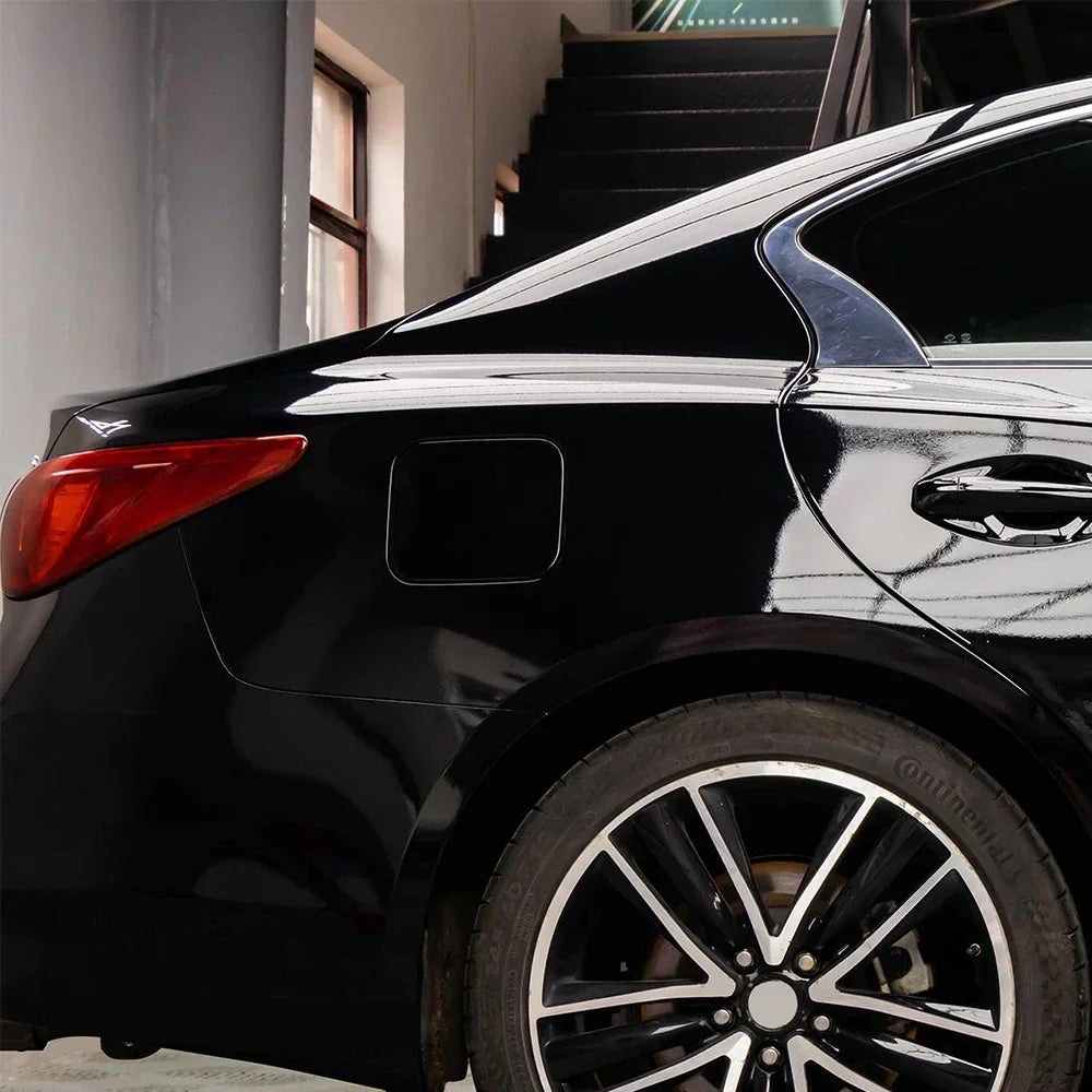 Glossy black car featuring silver decals and a black alloy wheel.