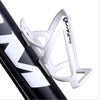 A white plastic bicycle bottle holder rack is shown mounted on a black bicycle frame.