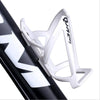 A white plastic bicycle bottle holder rack is shown attached to a black bicycle frame.