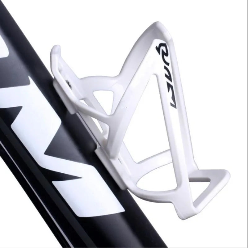 A white plastic bicycle bottle holder rack is shown attached to a black bicycle frame.