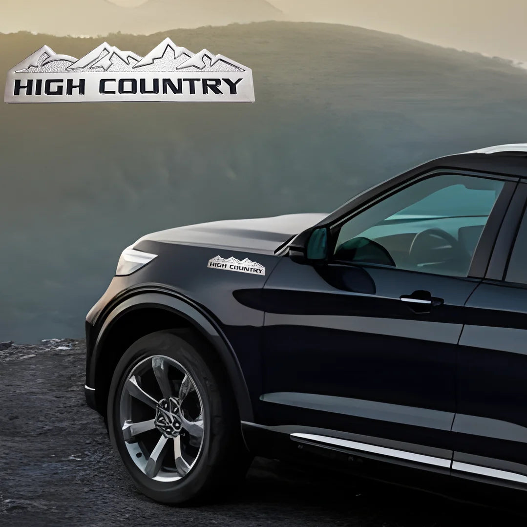 A dark SUV is parked on a dirt road with a sign reading HIGH COUNTRY in the background.
