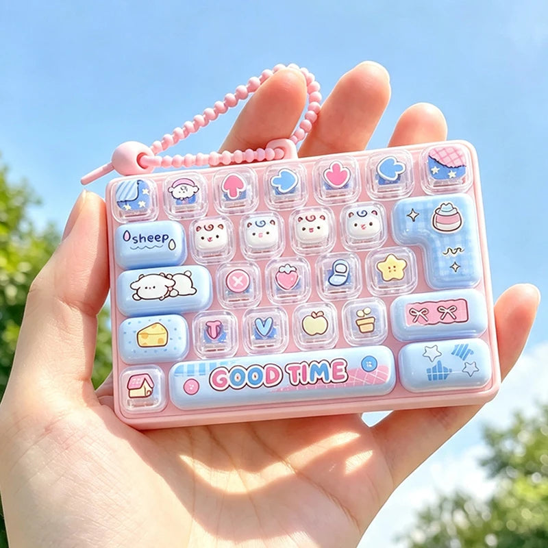 A hand holds a pink acrylic phone case featuring numerous colorful cartoon keycap stress relief buttons.