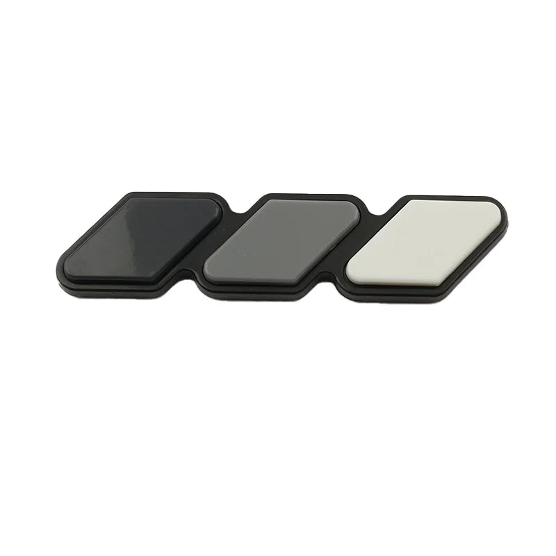 A set of three 3D car grill decals in black, gray, and white.