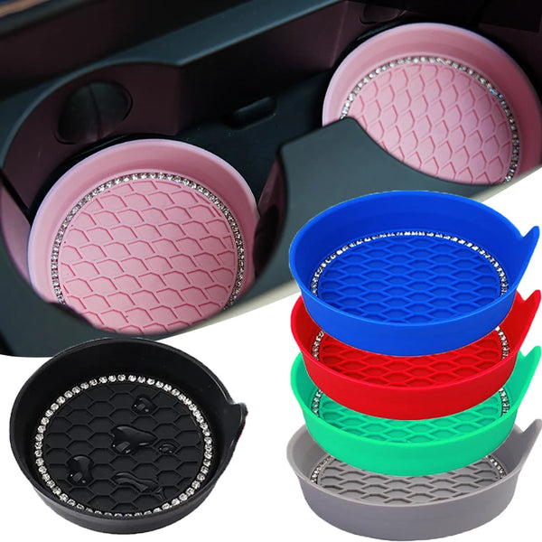 A set of silicone and plastic cup holders and coasters in pink, blue, red, green, and black with rhinestone accents.