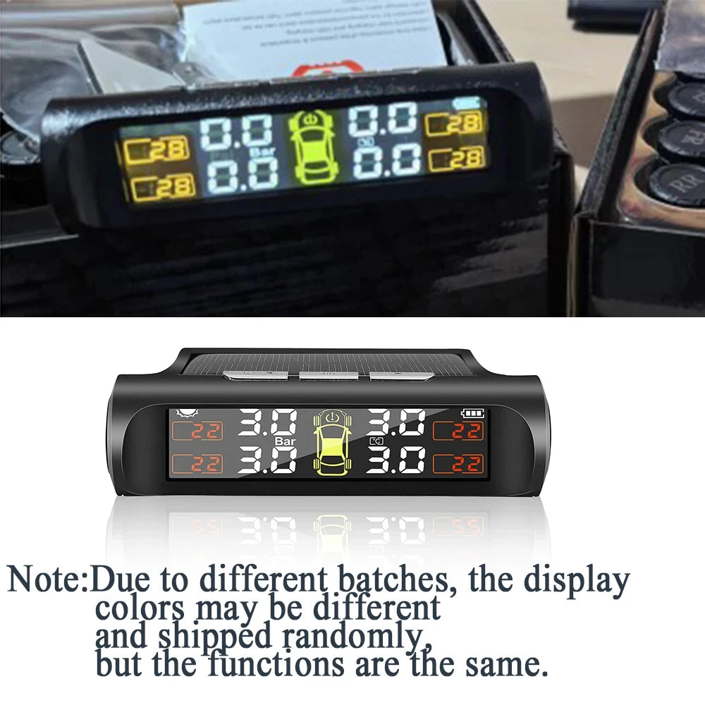 A black TPMS tire pressure monitoring system device displaying pressure readings on a digital screen.