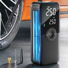 A black portable digital air pump device displaying a pressure reading of 2.50 bar, next to a tire and some metal accessories