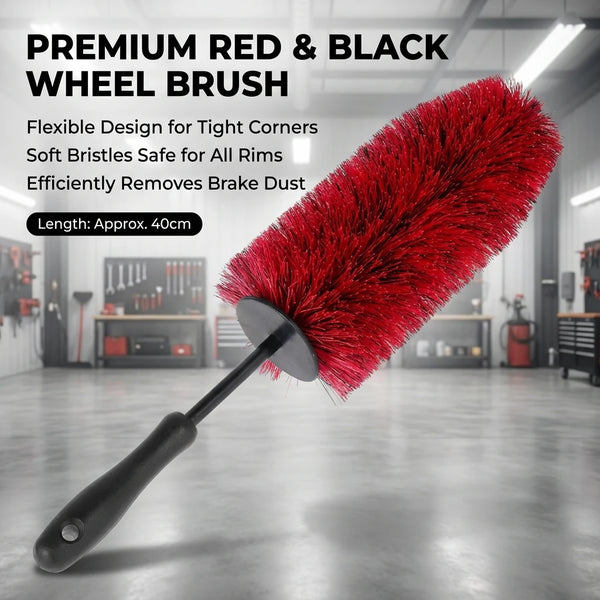 A red and black wheel brush with soft bristles is shown against a gray industrial background.