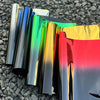 A collection of two-tone gradient car window tint film rolls displaying a spectrum of colors from black to yellow and red.