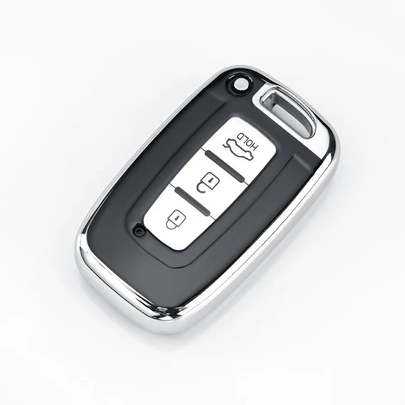 A silver car key case cover with multiple slots for different models.