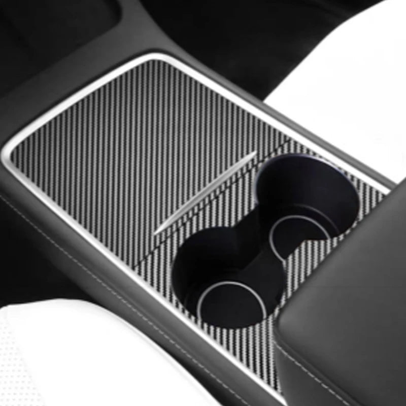 Interior view of a car dashboard featuring a wood grain cover and storage compartment.