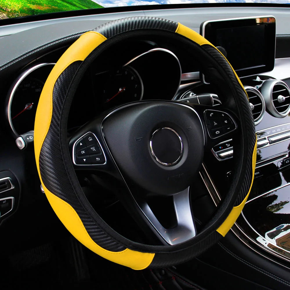 A black steering wheel with a yellow PU carbon fiber cover inside a car interior.