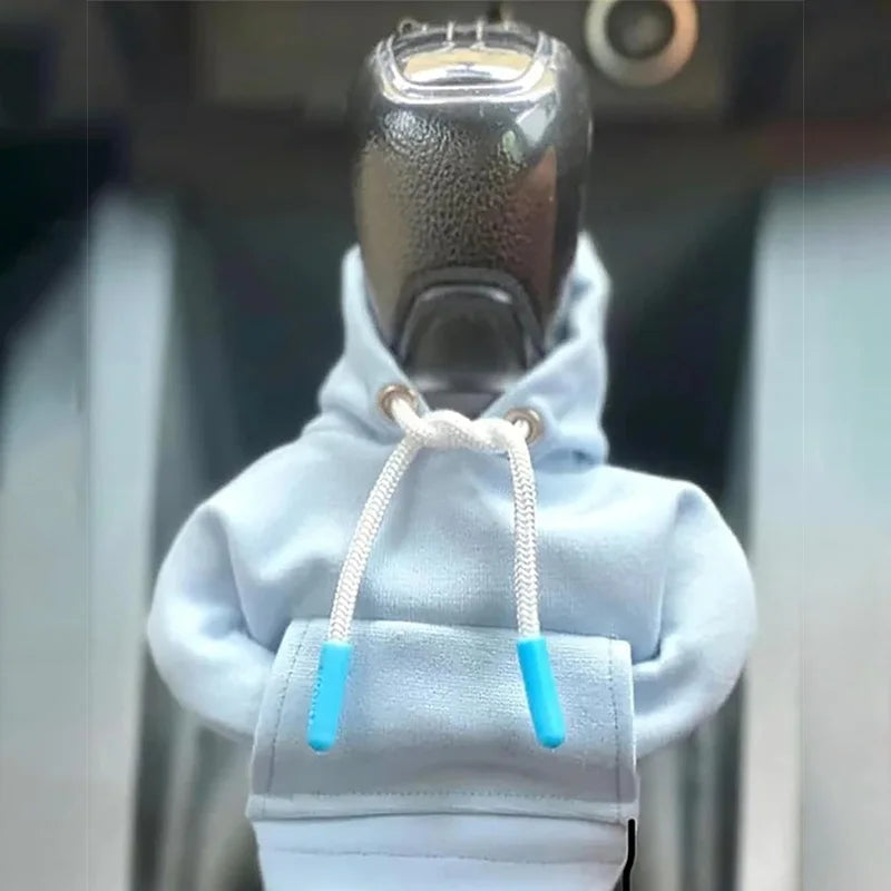 A light blue cozy knit hoodie with a shift cover attached, shown from the chest up.