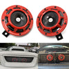 Two red electric air horn kits mounted on a vehicle grille and bumper.