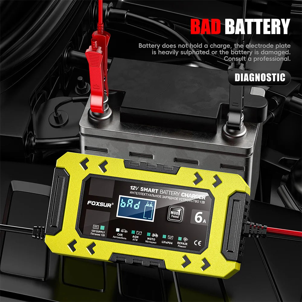 A yellow FoxSur smart battery charger is shown connected to a battery in a diagnostic context.