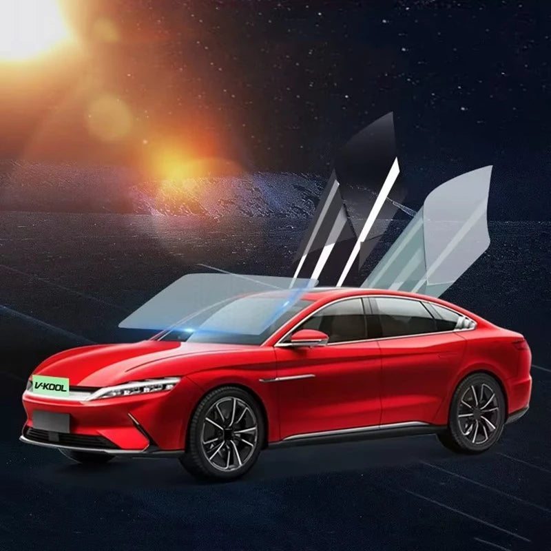 A red V-Kool car with black window tint film being applied against a dark, starry background.