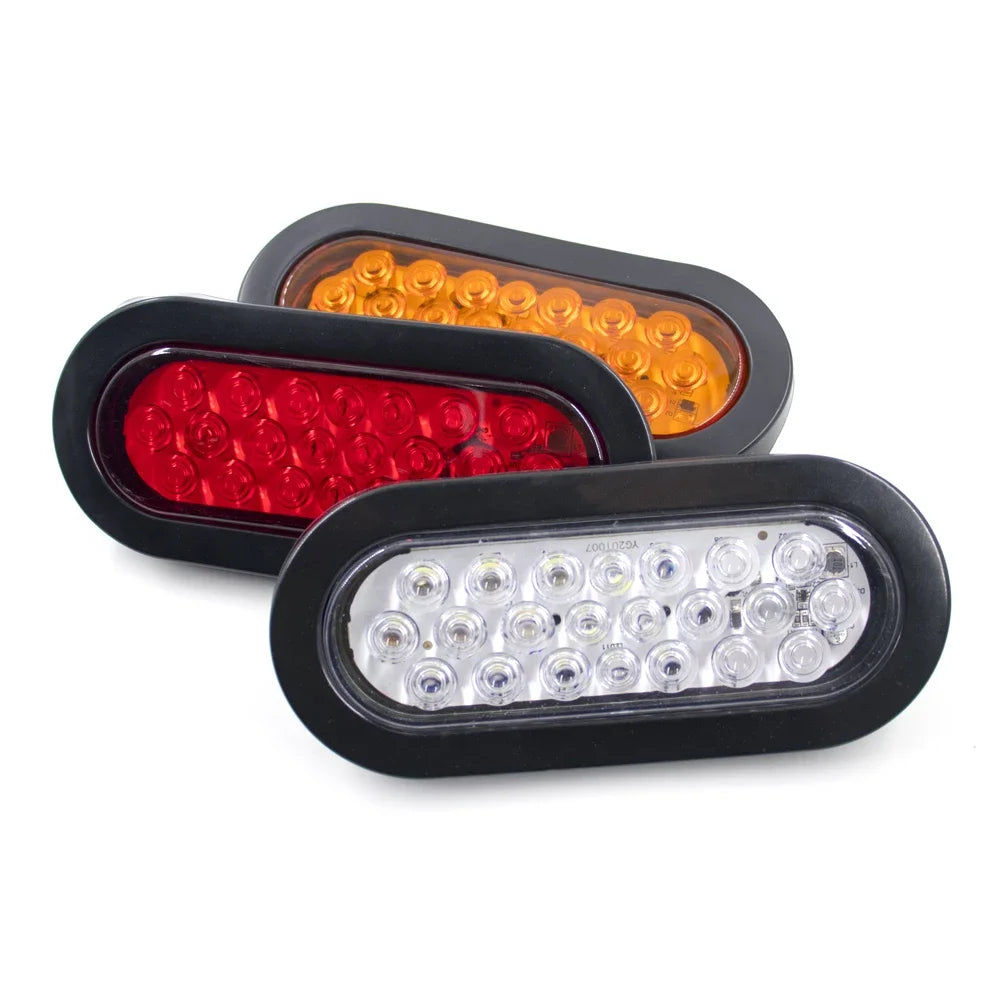 Three automotive LED brake and marker lights in red, amber, and clear lenses.