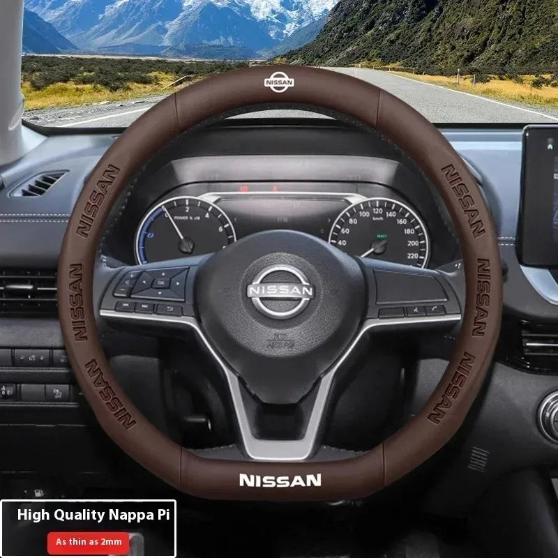 A close-up view of a brown leather steering wheel cover on a Nissan vehicle dashboard.