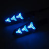 A row of three blue LED motorcycle turn signals glowing brightly against a dark background.
