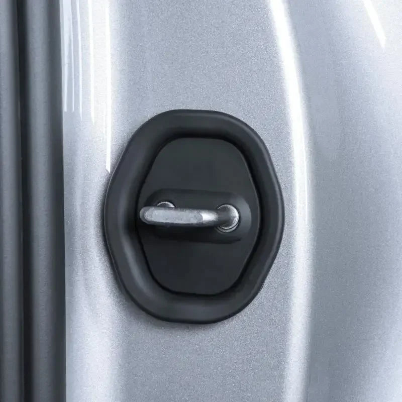 Close-up of a black silicone door damping guard installed on a silver car door.