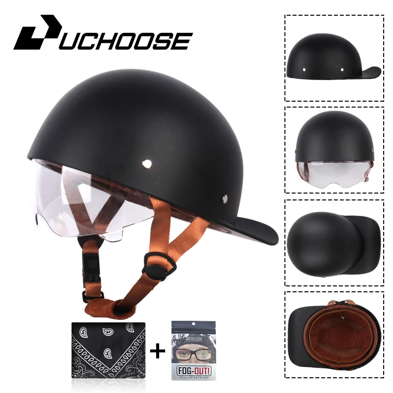 A black vintage open-face motorcycle helmet with a clear visor and brown leather strap, shown with accessories.