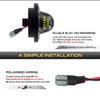 A black LED license plate light assembly with yellow illumination and polarized wiring connections.