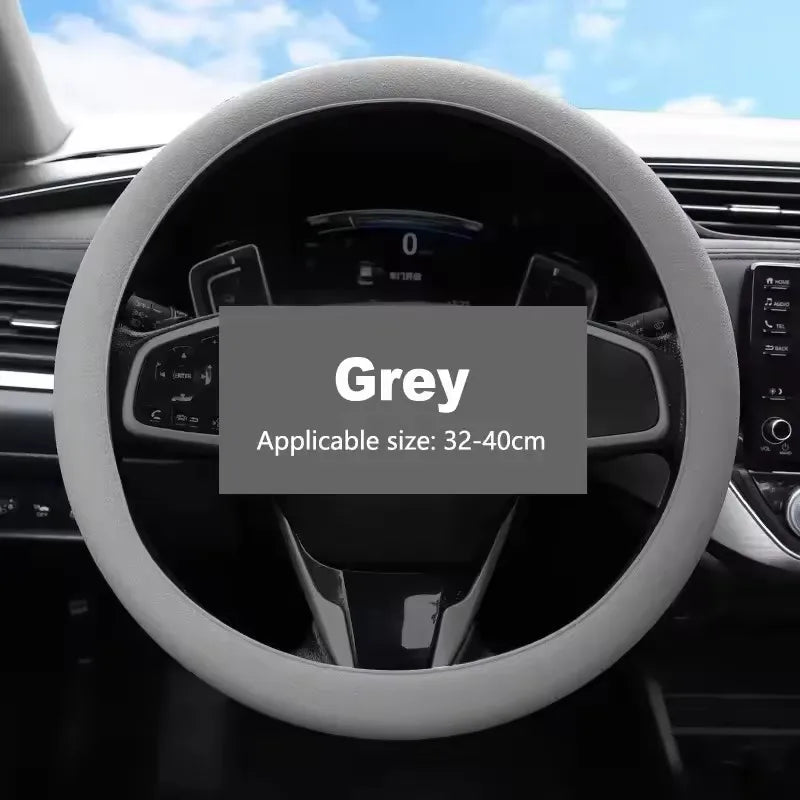 A grey universal silicone steering wheel cover installed on a car's steering wheel.