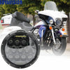 A white motorcycle with a custom 7 inch LED headlight mounted on the front.