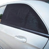 A close-up of a silver car window with a black mesh window screen installed.