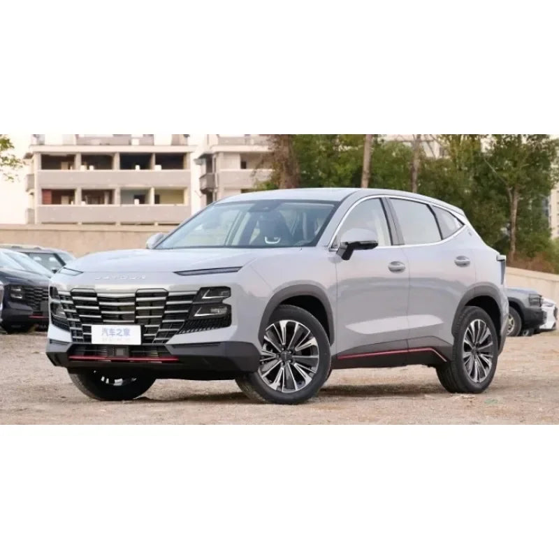 A silver SUV is shown outdoors, parked in front of a building.