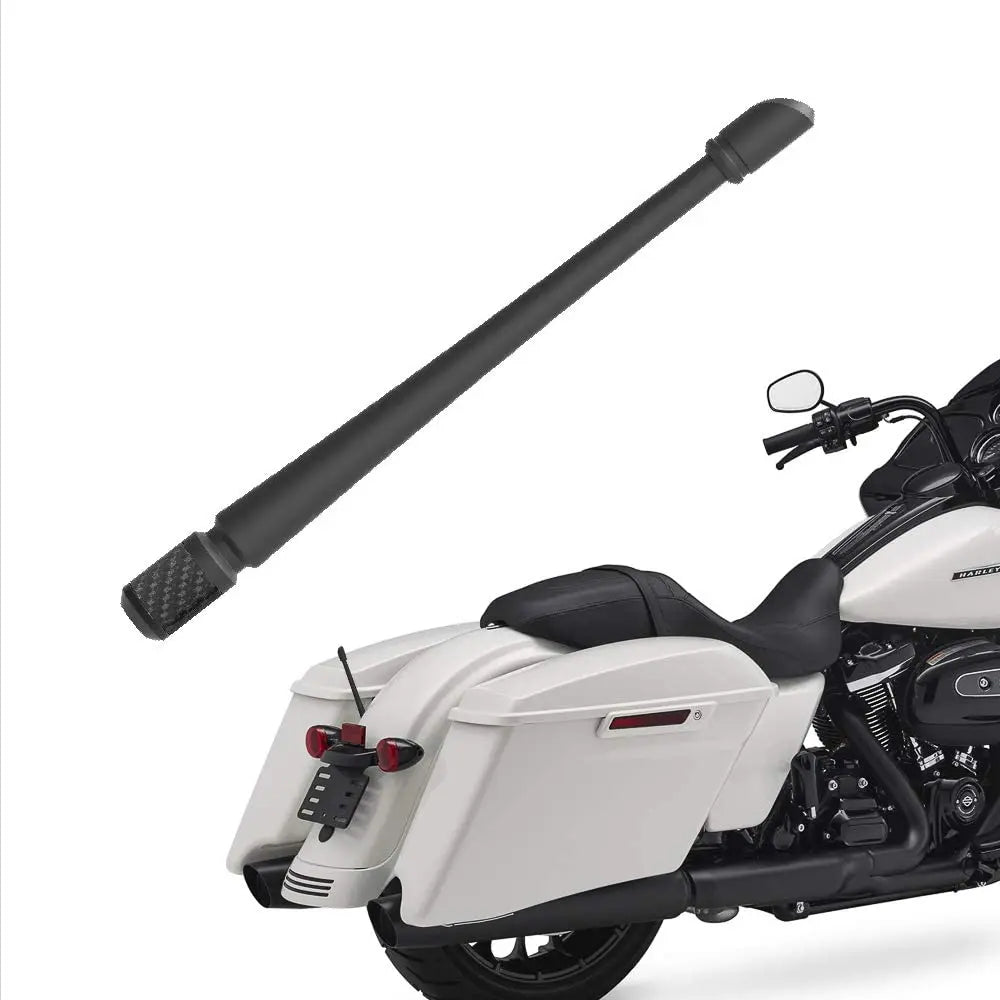 A black universal car antenna is mounted on a white motorcycle.