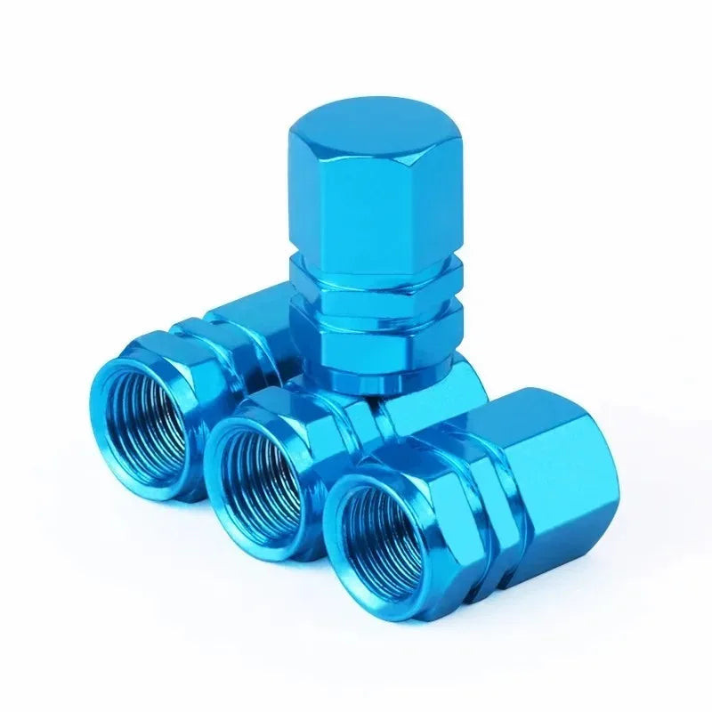 A close-up view of a bright blue aluminum valve cap.