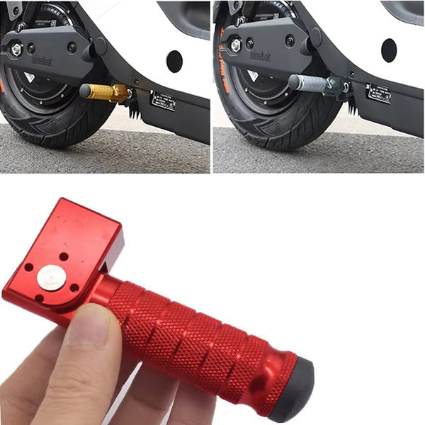 A hand holds a red, textured foot peg tool used for installing foldable aluminum alloy foot pegs on vehicles.