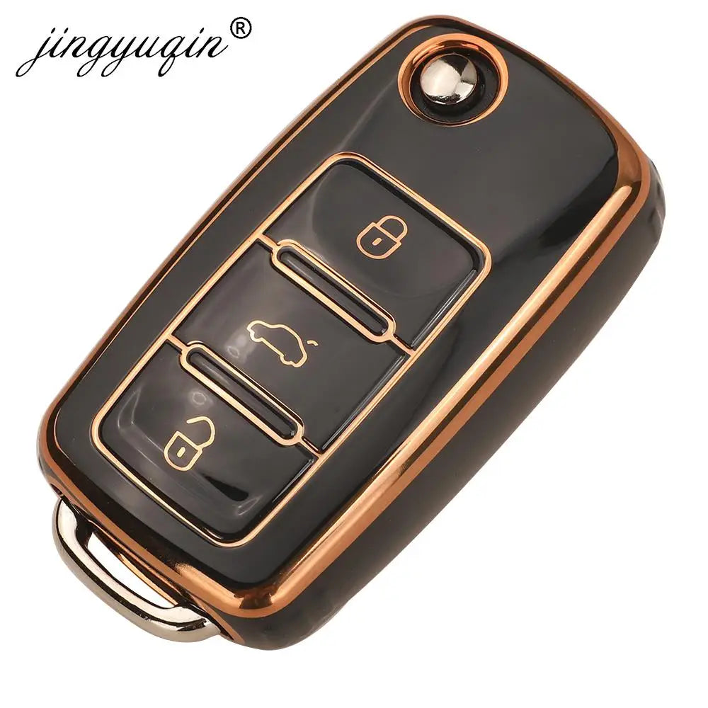 A black silicone TPU car key cover protector with multiple buttons and a gold trim ring.