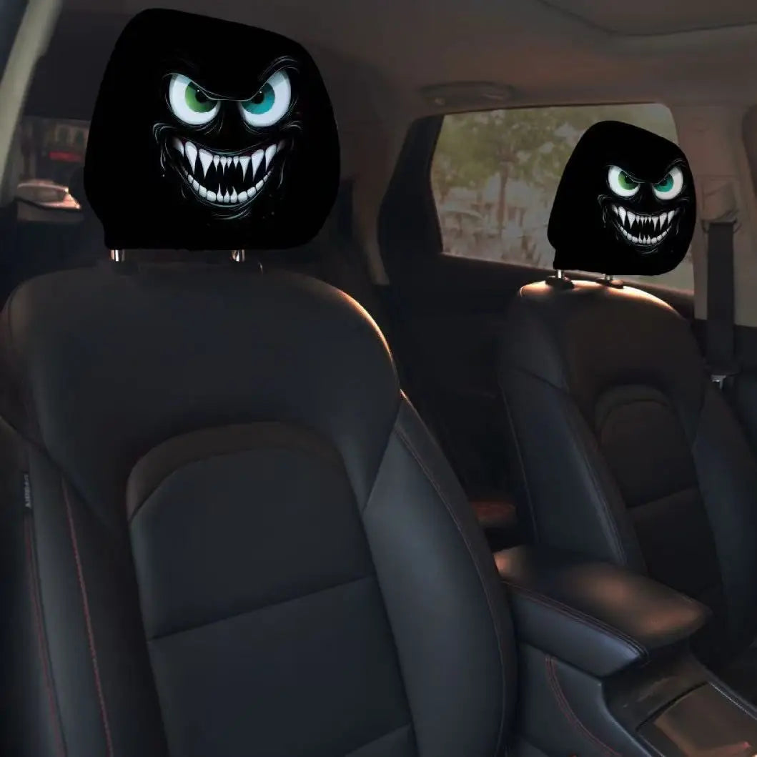 Two black horror themed car headrest covers with glowing green eyes are visible in a car interior.