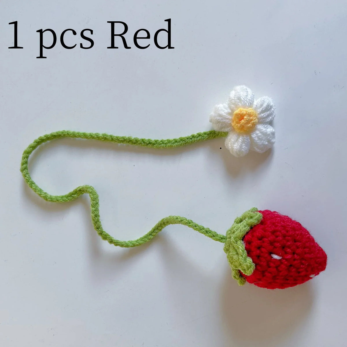 Fraise rouge crochet fait main avec tige verte et fleur blanche, utilisée comme pendentif ou porte-clés.