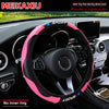Pink and black carbon fiber steering wheel cover installed in a car interior.