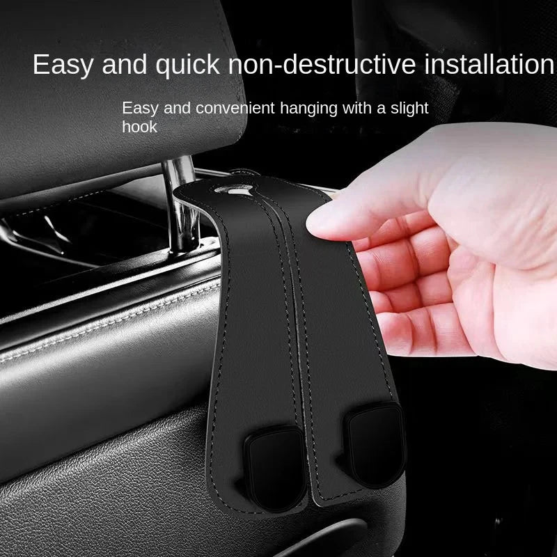 A hand is installing a non-destructive car headrest hook for bag organization onto a vehicle seat.