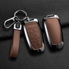 A brown leather strap attached to an aluminum alloy key fob cover for a Ford vehicle.