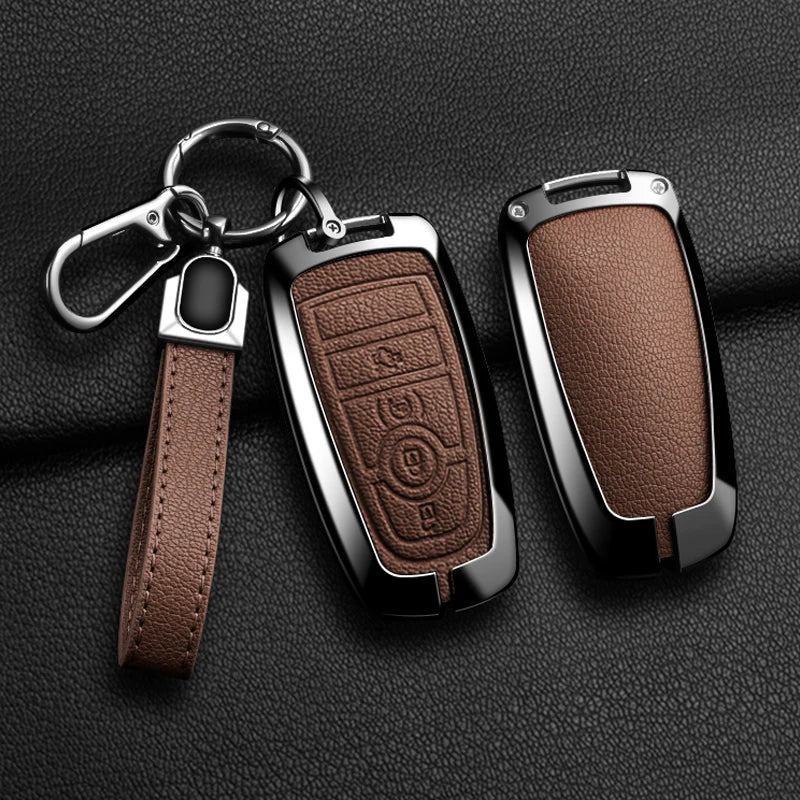 A brown leather strap attached to an aluminum alloy key fob cover for a Ford vehicle.