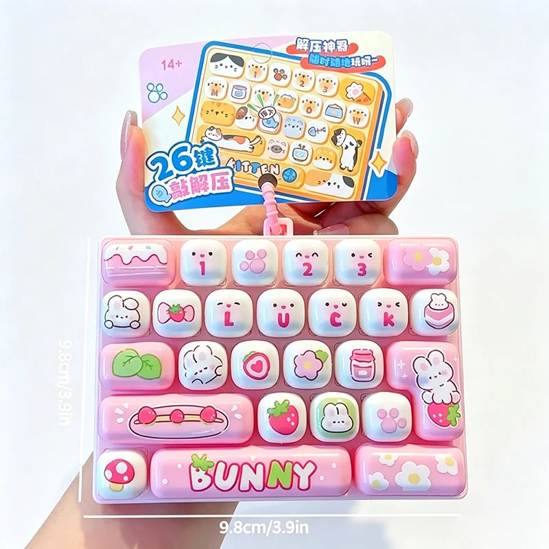 A set of pink and white cartoon keycap stress relief buttons with a bunny theme is displayed in a hand.