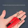 A hand holds a small red 3-in-1 car emergency safety tool kit with a metal chain attached.