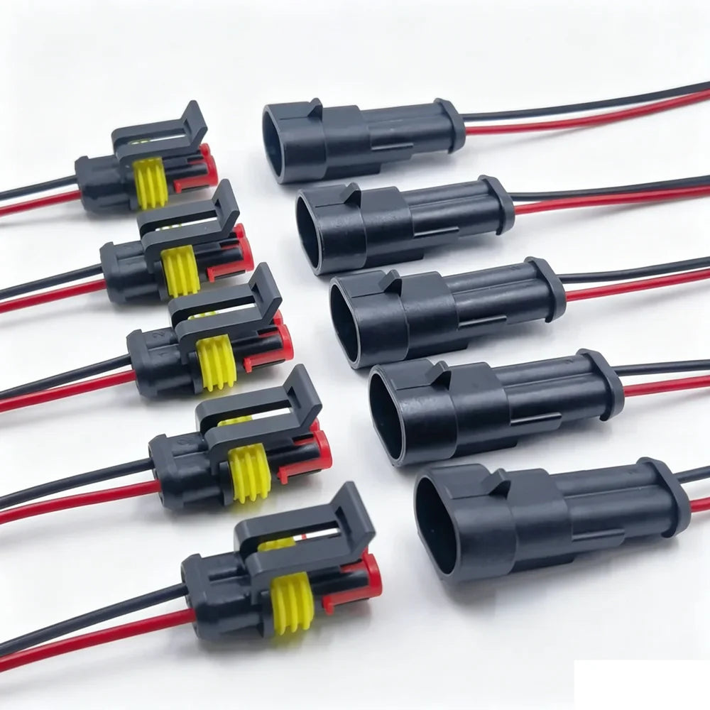 A collection of waterproof electrical connectors with pre-wired red and black leads.