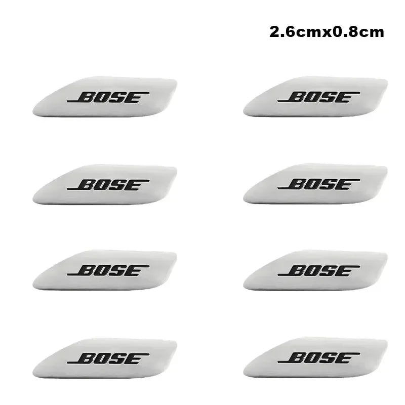 A set of black and white 3D aluminum car audio emblems with the brand name BOSE.