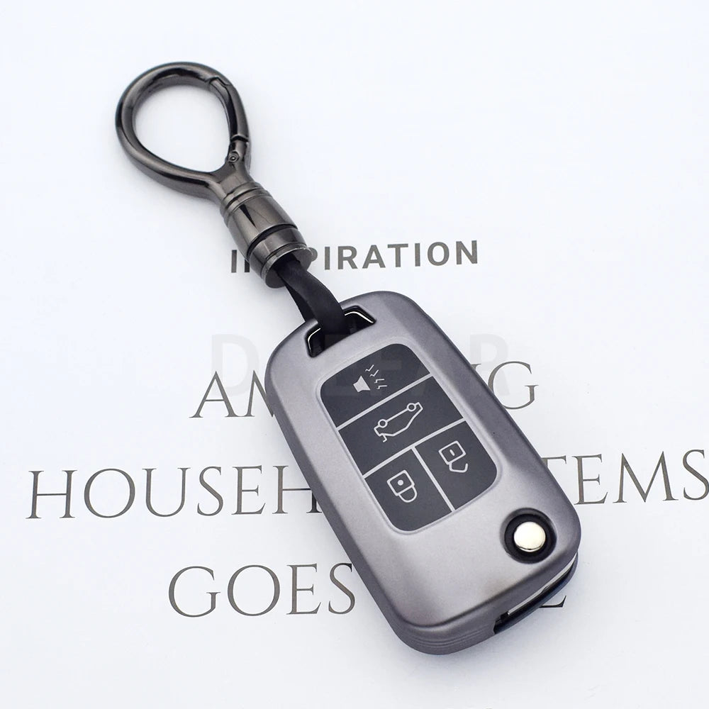 A silver universal car key cover with a metal loop and buttons for various vehicle keys.